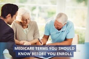 Senior reading Medicare enrollment guide at kitchen table